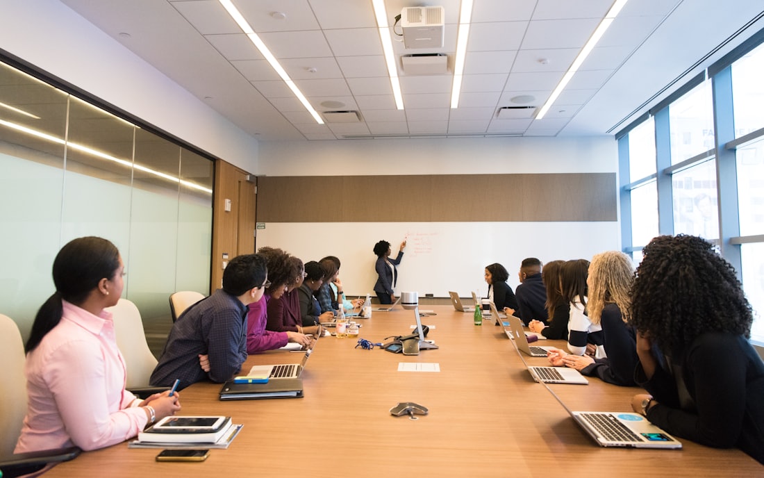 Colleagues seated around a long meeting table